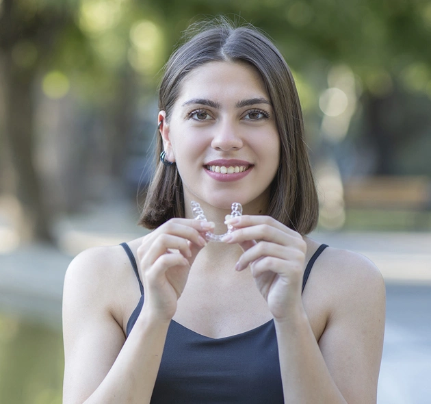 Young woman breaking cigarette outdoors, promoting healthy smile and dental wellness